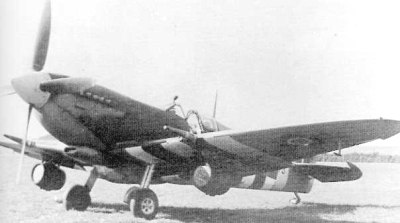 Spitfire with beer kegs on ground